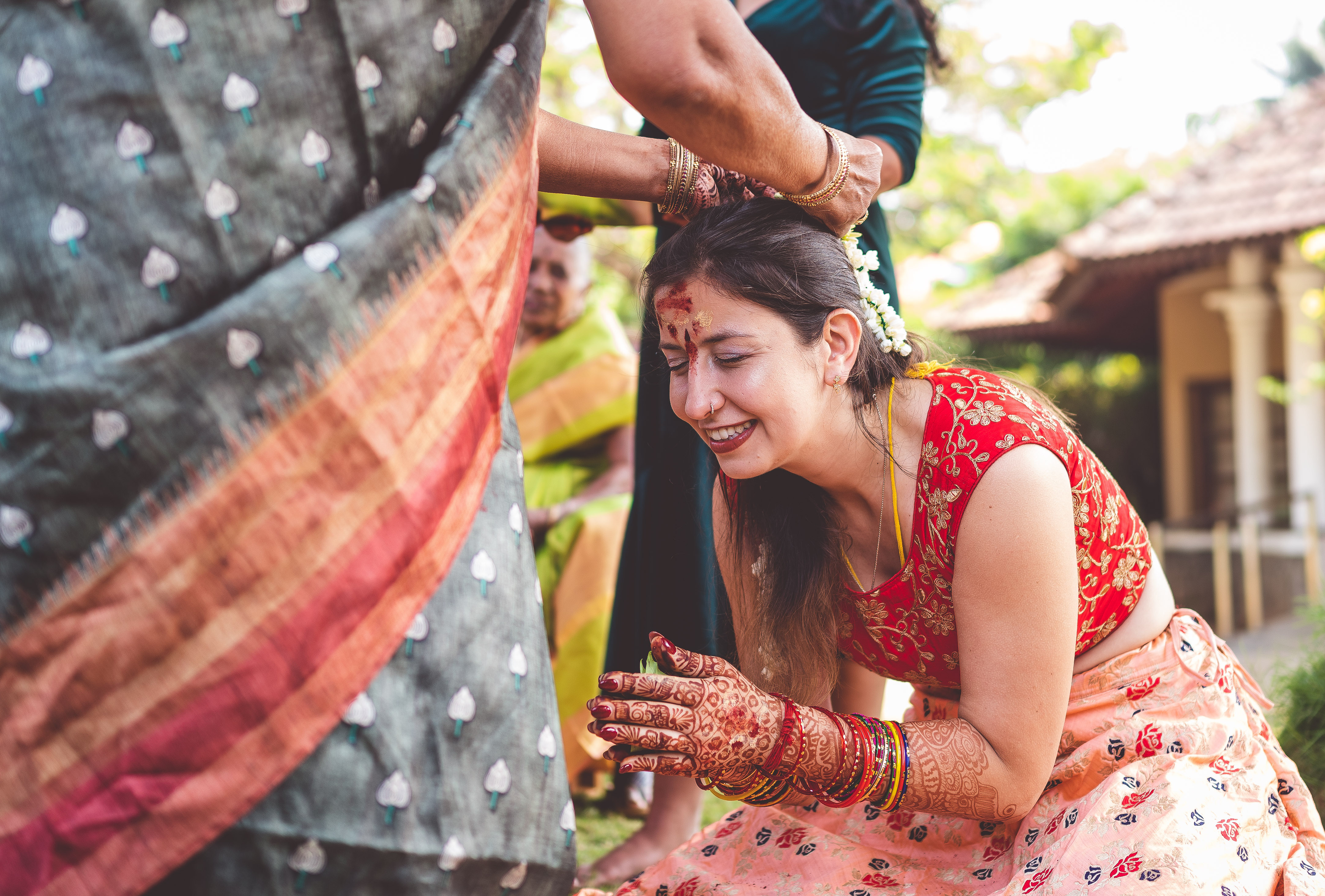 Participant in traditional Indian attire bowing respectfully at sacred temple during authentic cultural immersion experience